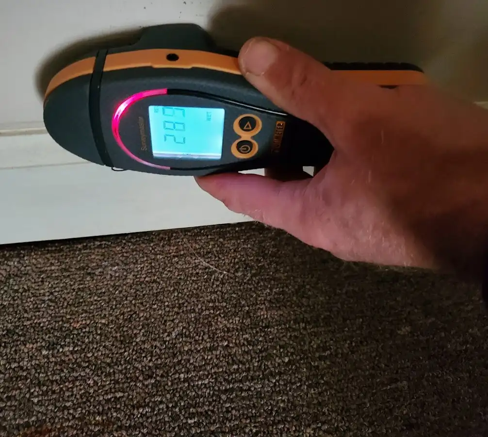 Moisture detection at baseboard during Storm Damage Restoration in Oak Ridge